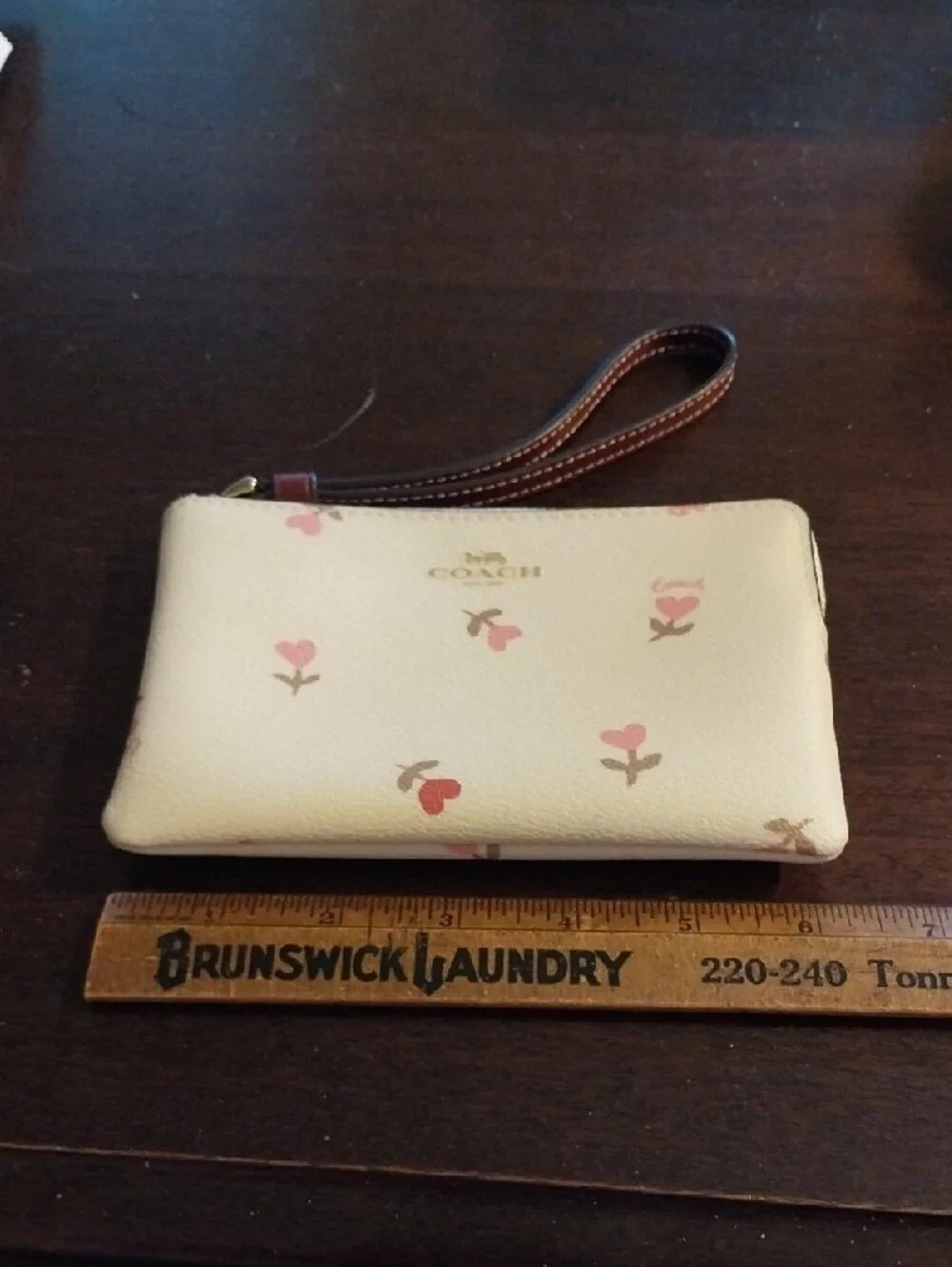 Coach Cream Wristlet with Pink Floral Accents and Brown Strap